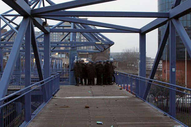 French police squad getting ready to shoot tear gas at the crowd assembled to protest police crimes in Bobigny (northeastern Paris banlieue). / Photograph by Léopold Lambert (2017).