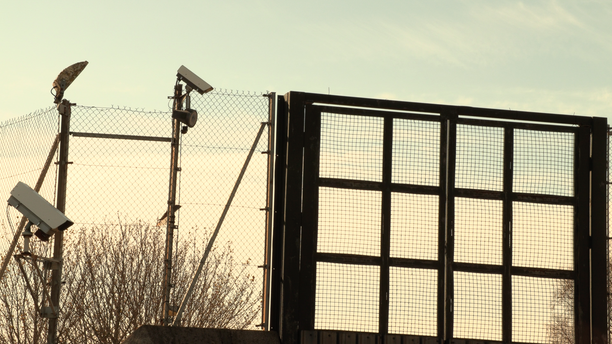 Barrier around an immigration detention centre. Hope Street, Larne, Northern Ireland. Credit: Emmet Thornton