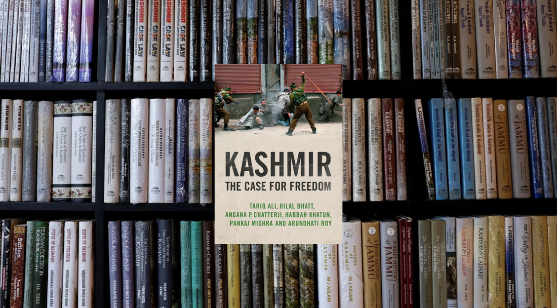 Shelves of books on Kashmir stand behind the cover of Verso's "Kashmir: The Case for Freedom"