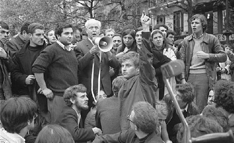 Daniel Cohn-Bendit raises his arm to allow Louis Aragon to speak, May 1968. Photo: Serge Hambourg. via Flickr. 