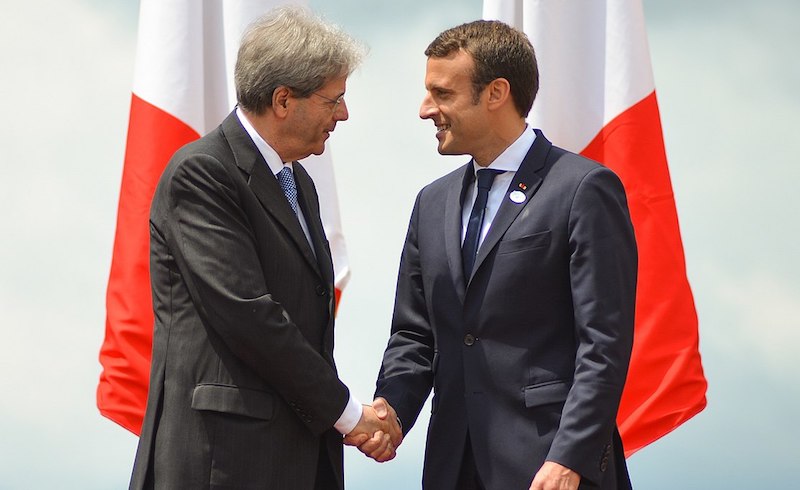 Italian Prime Minister Paolo Gentiloni shakes hands with Emmanuel Macron at the G7 summit, May 2017. via Wikimedia Commons. 