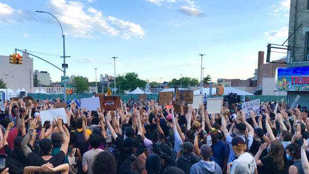 Protesters in Brooklyn this week, with white protestors forming a front barrier around the cops. Photo by Audrea Lim
