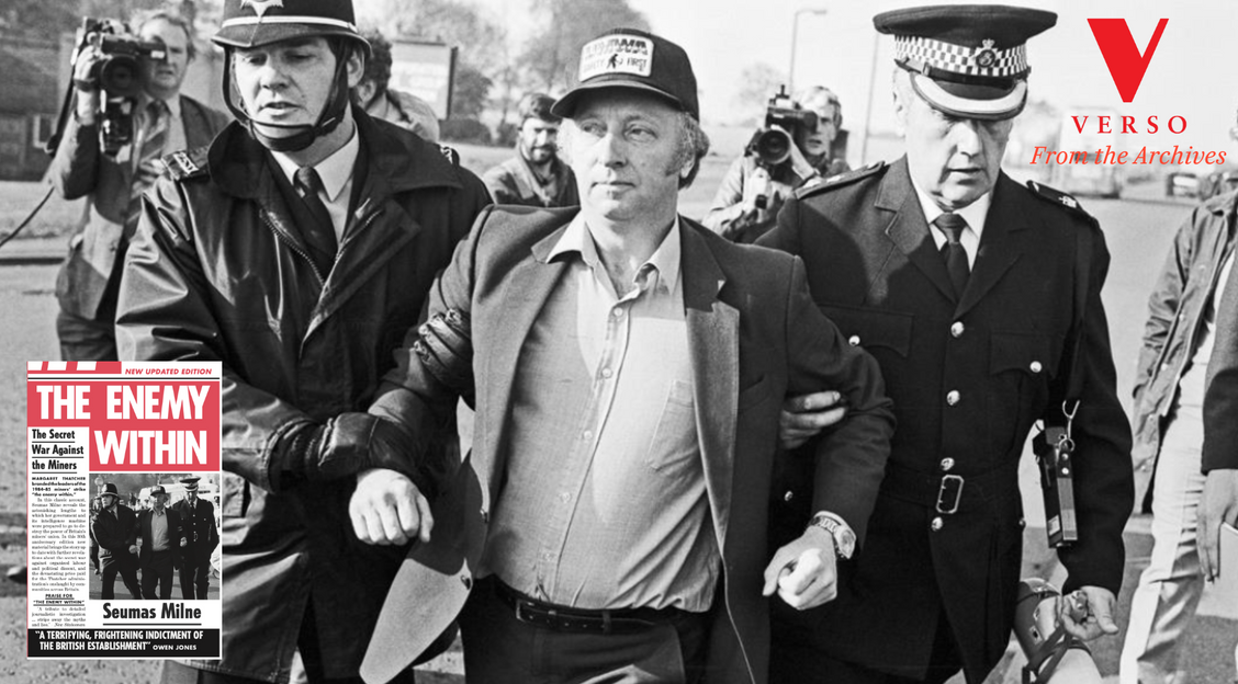 A black and white photograph of union leader Arthur Scargill being escorted away from the factory by the police (1984). In the bottom left corner sits the cover image for Seumas Milne's The Enemy Within, and the top right corner has a Verso logo.