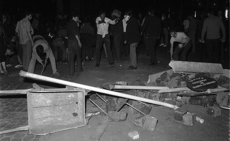 Students in Toulouse construct a barricade, June 11 1968. via Wikimedia Commons.