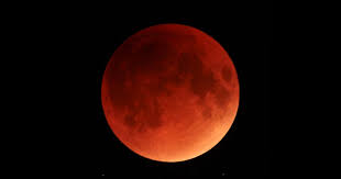 A big, red moon hanging low in the sky