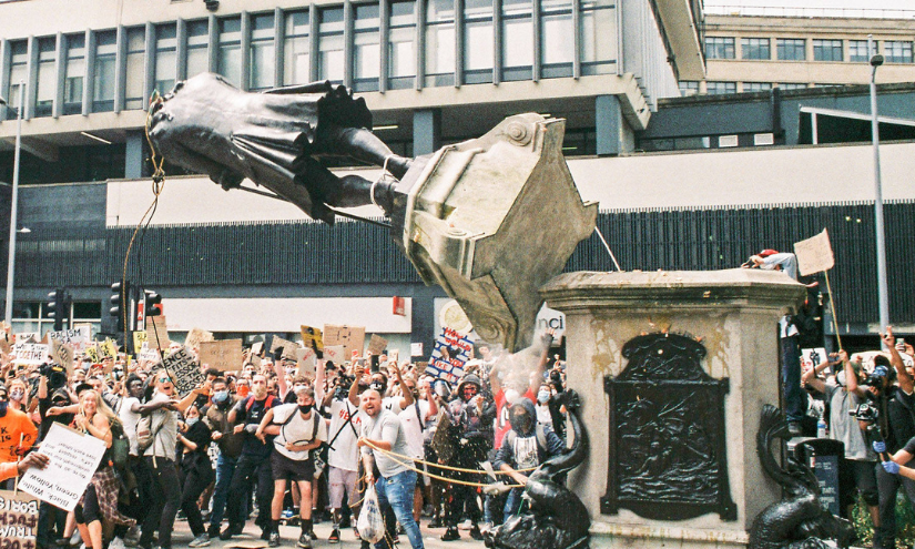 A statue of slave trader Edward Colston being toppled.