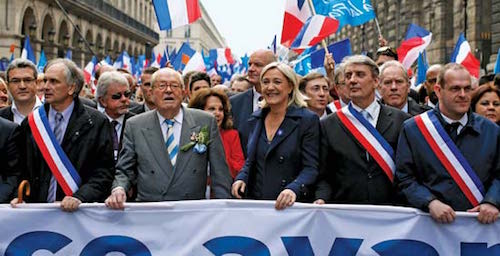Marine and Jean-Marie Le Pen lead an FN march, 2014.