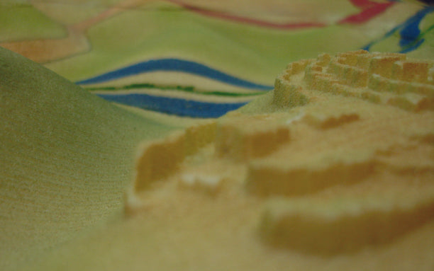 A topographical model of the Beit Surik area with different possible walls. In red is the route built by the government, in blue is the “lesser evil” line. Note that the blue line crosses the green line. Photo: Eyal Weizman, 2008.