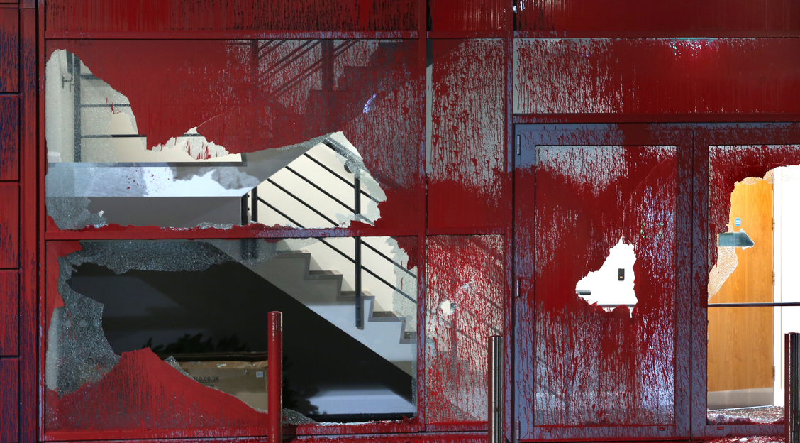 broken windows splashed with red paint