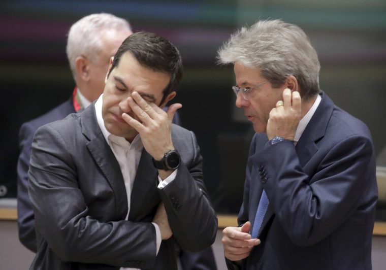 Italian Prime Minister Paolo Gentiloni, right, speaks with Greek Prime Minister Alexis Tsipras during a round table meeting of eurozone countries at an EU summit in Brussels on Friday, March 23, 2018. (AP Photo/Olivier Matthys)